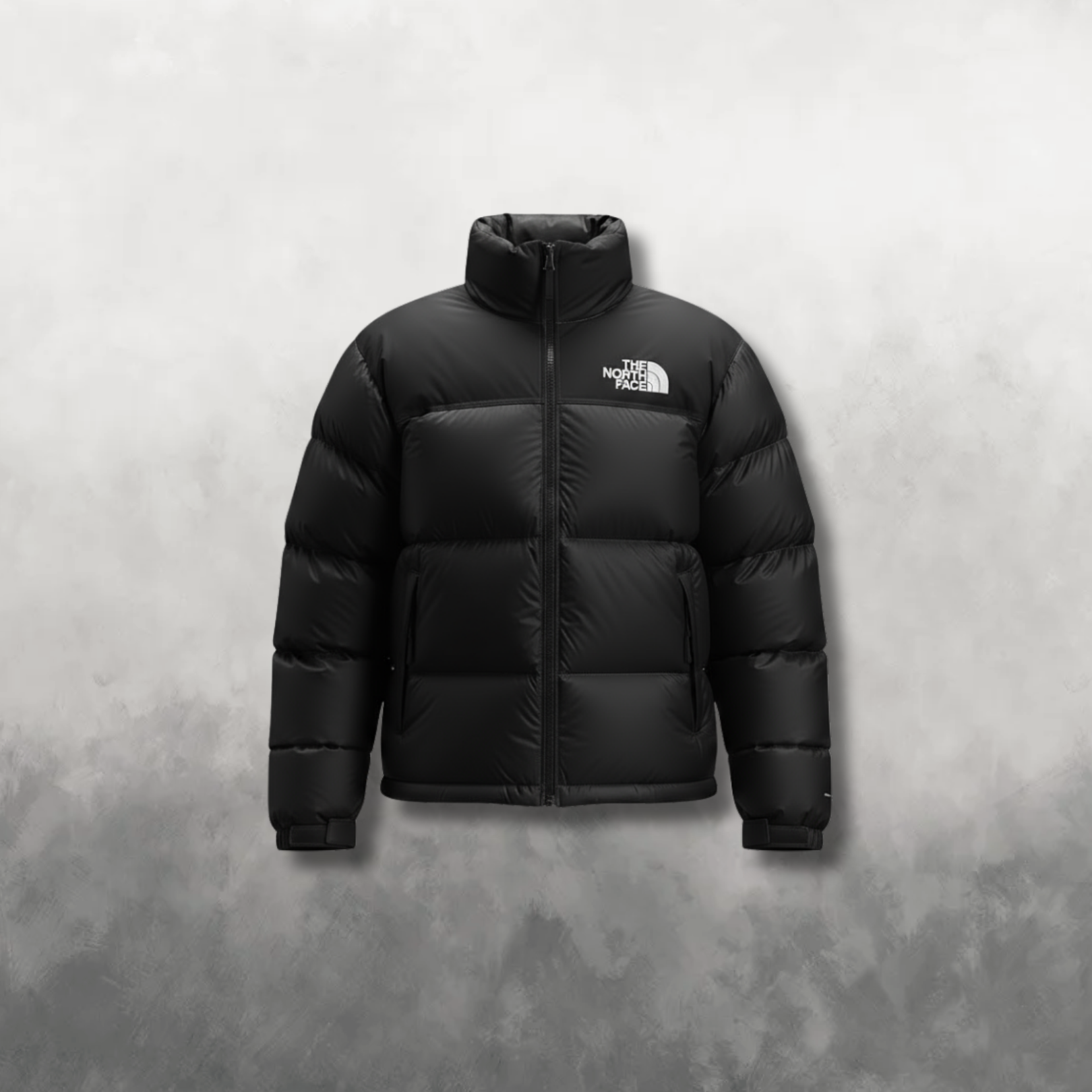 Black puffer jacket with brand logo on a gray background