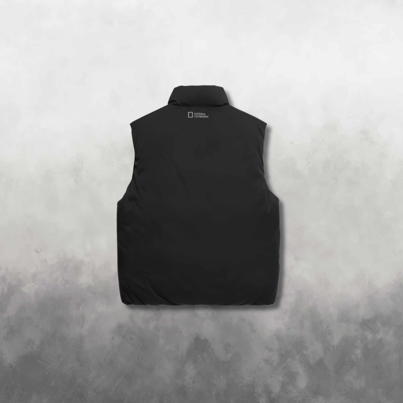 Back view of a black vest with a brand logo on the back against a gray background