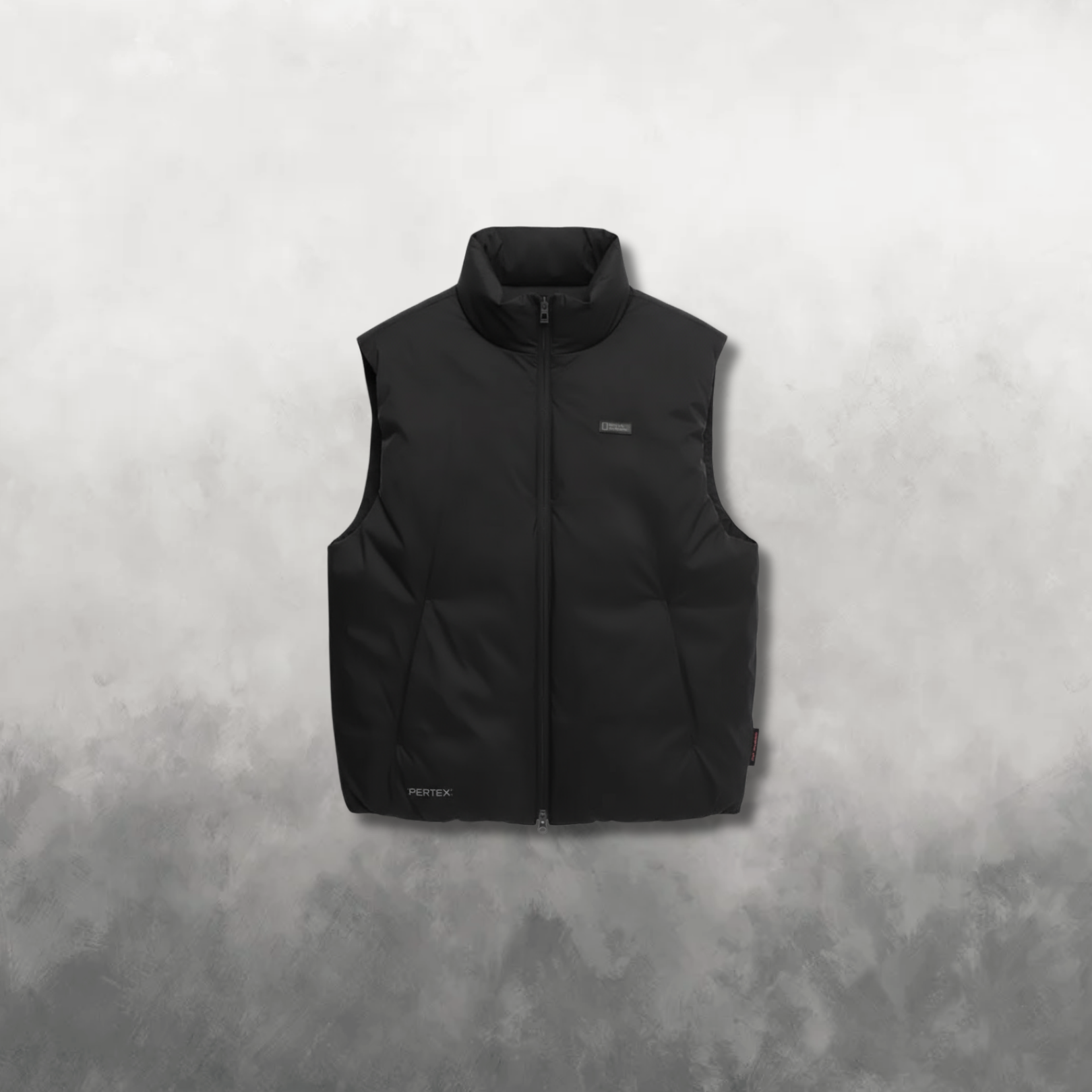 Black puffer vest on a textured gray background