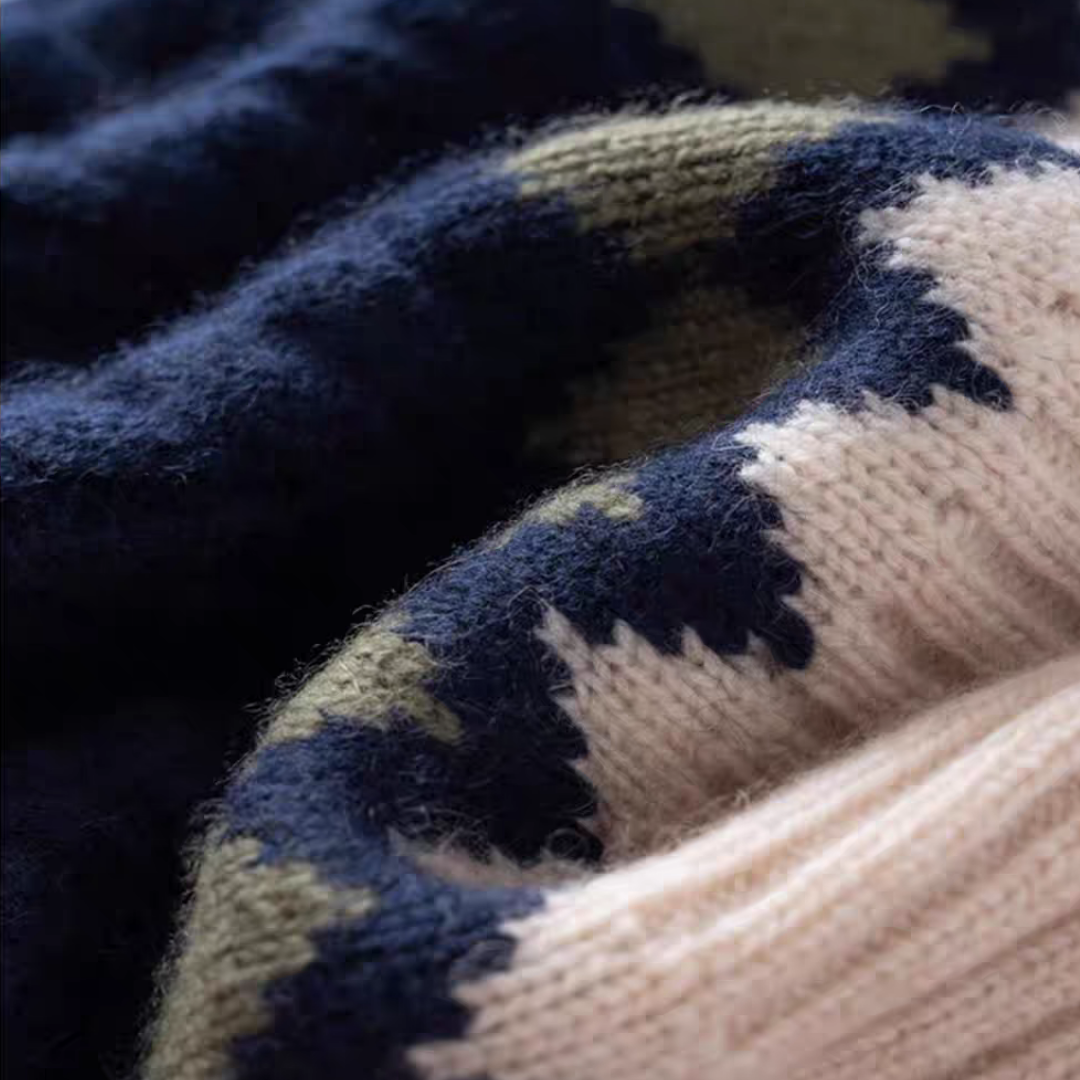 Close-up of a knitted cashmere fabric with blue and beige pattern