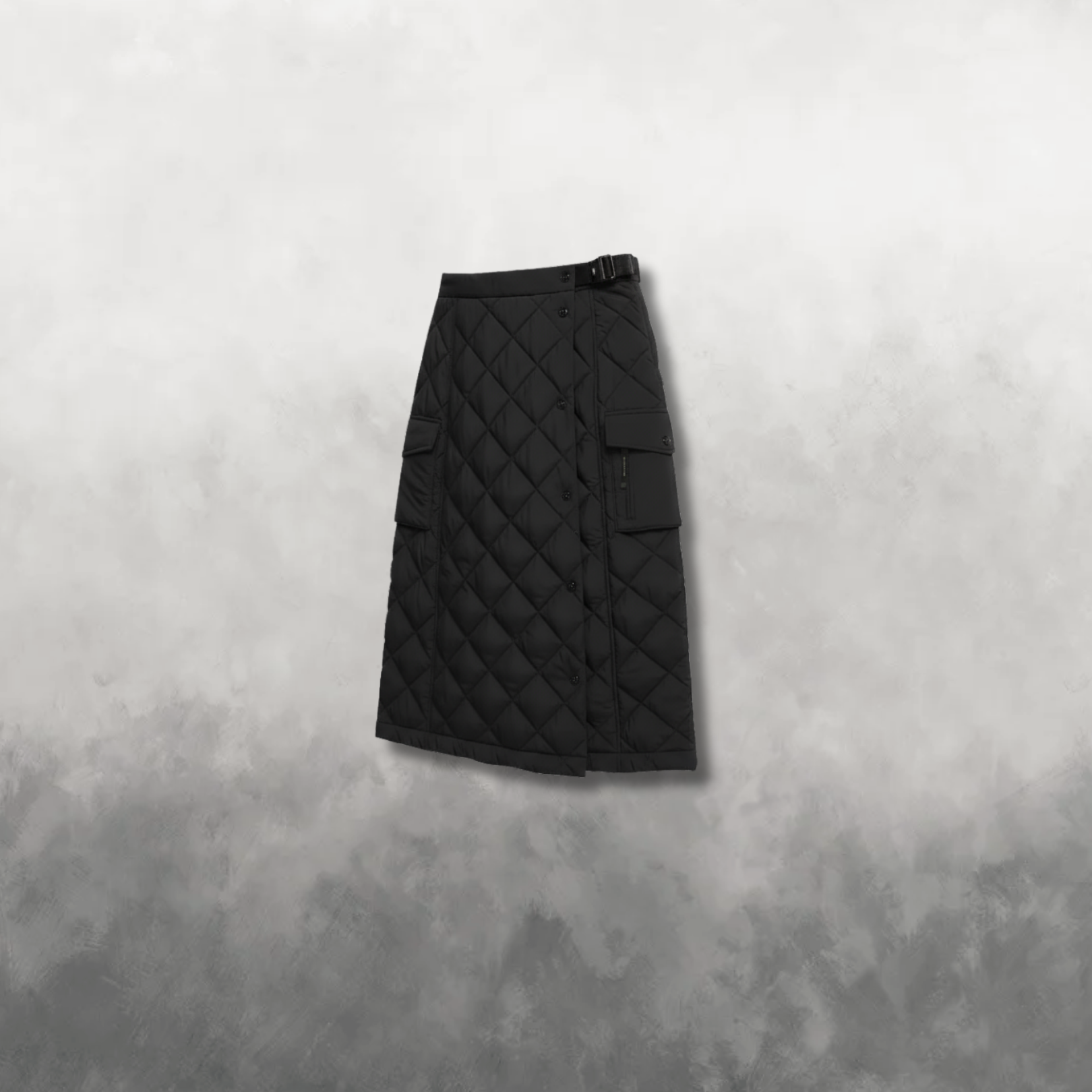 Black quilted skirt on a textured gray background