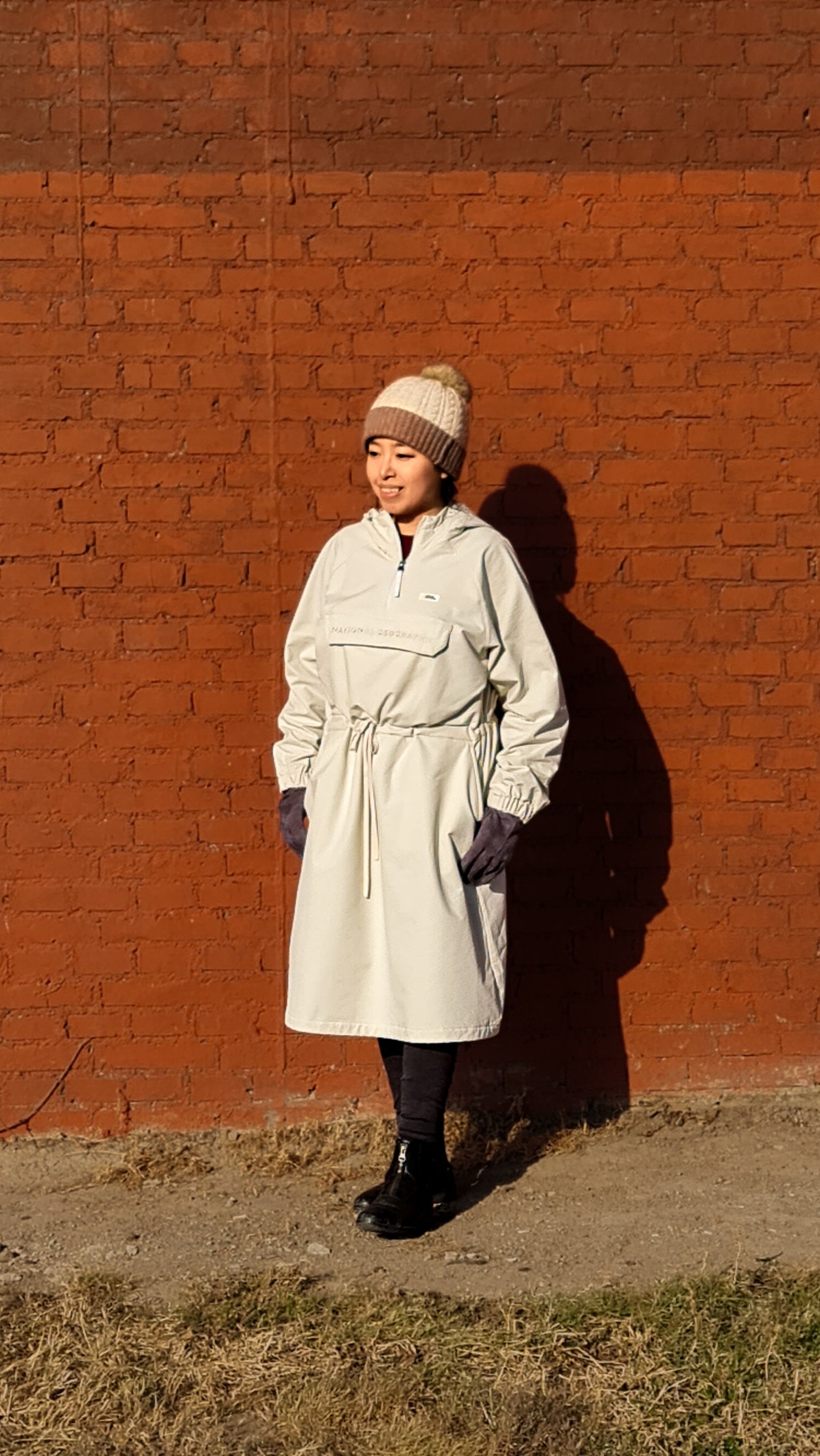 Lady at a Red Brick Wall wearing National Geographic Warm Fleece Woven Dress, Cream